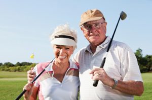 Senior couple, 70s, on the golf course.